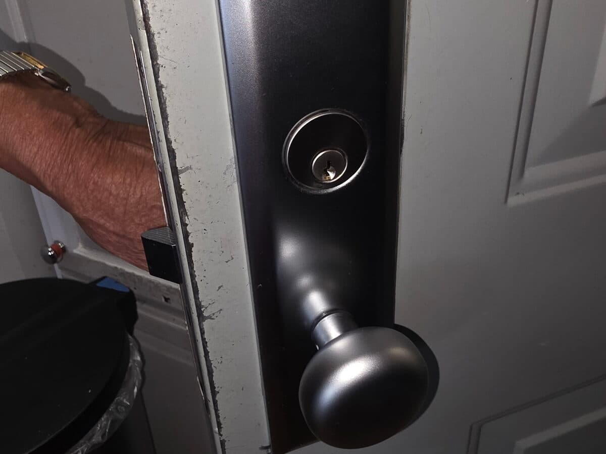 Locksmith installing a deadbolt lock on a door