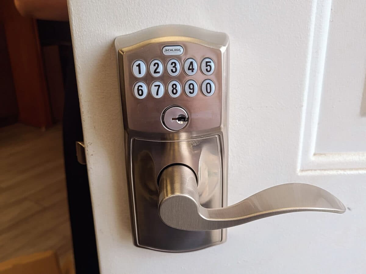 Keypad smart deadbolt with a lever handle installed on a door
